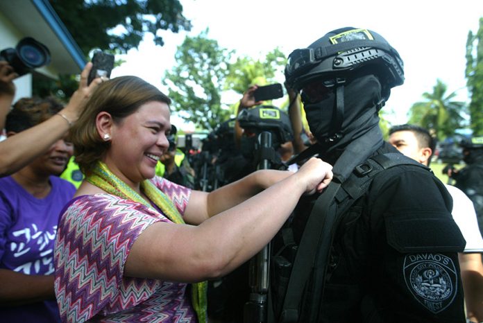 RECOGNITION. Davao City Mayor Sara Duterte-Carpio leads the ceremonial pinning of Special Weapons and Tactics (SWAT) operator pin during the SWAT’s graduation ceremony after about a month of training under the Davao City Police Office on Thursday.