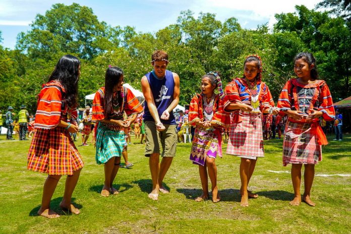 GRAND WINNER. Kulas, a photo showing a white man being taught an Indigenous People’s traditional dance by William Lee Chin, is the grand winner of this year’s Hulagway sa Kadayawan photo contest. CIO