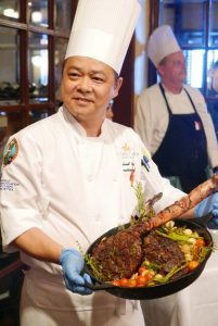 Pacific Star Resort and Spa’s chef Leyland Feng shows off his signature 28-day wet aged Tomahawk steak.