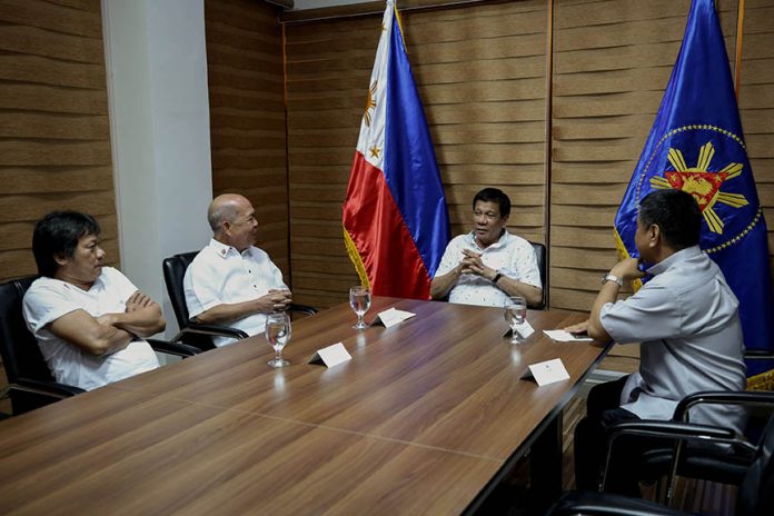 DIALOGUE.President Duterte meets with Catholic Bishops' Conference of the Philippines (CBCP) President Romulo Valles at the Matina Enclaves in Davao City on Saturday evening. Also in the photo are Fr. Emmanuel Gonzaga and Msgr. Paul Cuison. SIMEON CELI JR./PRESIDENTIAL PHOTO