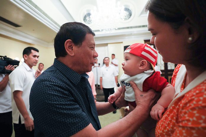 DOTING GRANDPA. President Duterte spares time for his grandson to Davao City Mayor Sara Duterte-Carpio, Marko Digong on the sidelines of the 6th Mandatory Continuing Legal Education (MCLE) Accredited National Convention of Public Attorneys opening ceremony at the Tent City in Manila Hotel, Manila on Monday night. ACE MORANDANTE/PRESIDENTIAL PHOTO