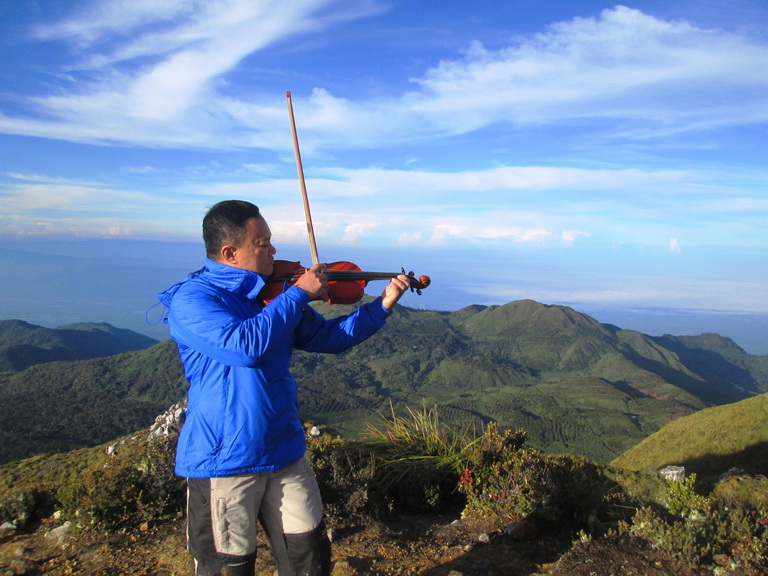 Making history by being the first person to play the violin at the summit of Mt. Apo.