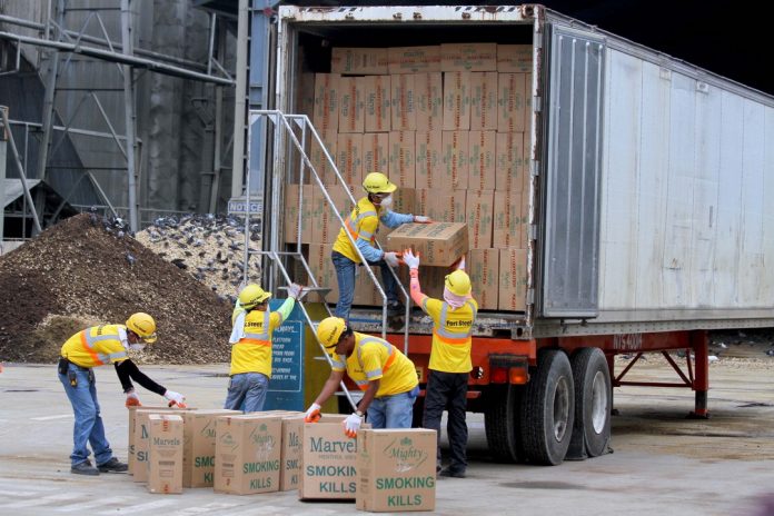 REDUCED TO ASH. Workers unload cigarettes with counterfeit tax stamps seized from Mighty Corporation earlier this year for incineration at the Holcim Philippines plant in Brgy. Ilang, Davao City on Sunday. LEAN DAVAL JR.