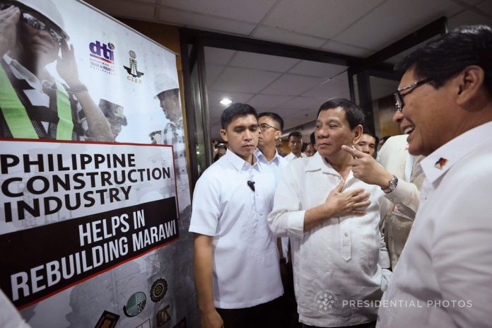 TIME OUT FOR LABOR. President Rodrigo Duterte is welcomed by Labor and Employment Secretary Silvestre Bello III to the 2nd Philippine Construction Congress at the Philippine International Convention Center in Pasay City on Tuesday. The President was only scheduled to attend the Anti-Corruption Summit 2017: 'Breaking Chains of Corruption 2017' yet he decided to grace the construction congress. PRESIDENTIAL PHOTO