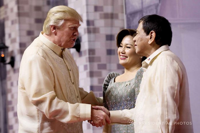 TRUMP IN PERSON. President Rodrigo Duterte and his partner Honeylet welcome US President Donald Trump prior to the start of the gala dinner hosted by the Philippines for the leaders of the Association of Southeast Asian Nations (ASEAN) member states and dialogue partners at the SMX Convention Center in Pasay City on Sunday evening. PRESIDENIAL PHOTO