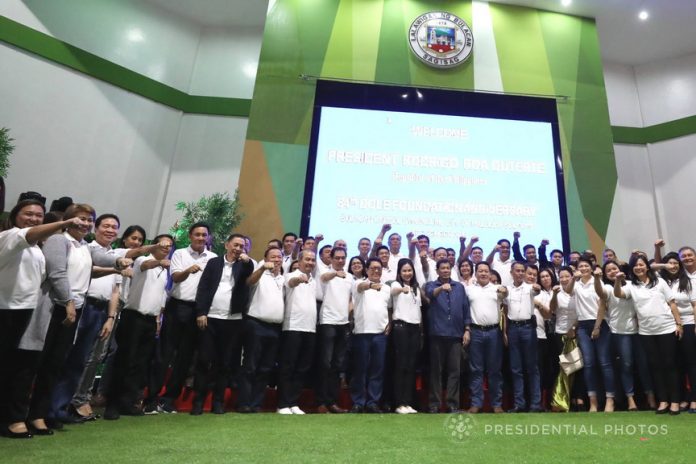 President Rodrigo Roa Duterte flashes his signature pose with the officials of the Department of Labor and Employment (DOLE) during the agency’s 84th Anniversary Celebration at the Bulacan Capitol Gymnasium in Malolos City on December 8, 2017. KARL NORMAN ALONZO/PRESIDENTIAL PHOTO