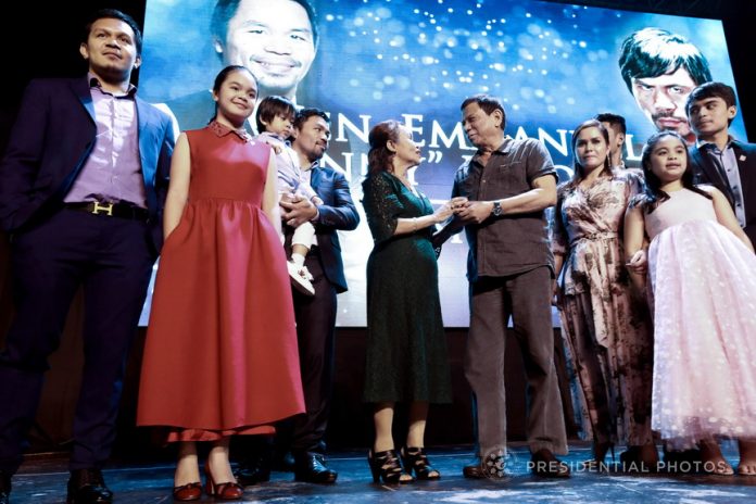 LIGHT MOMENTS. President Rodrigo Duterte chats with Senator Emmanuel Pacquiao's mother Dionesia Pacquiao before they pose for a photo with the Senator and his family during the Senator's birthday celebration at the KCC Convention and Events Center in General Santos City on Sunday evening. PRESIDENTIAL PHOTO