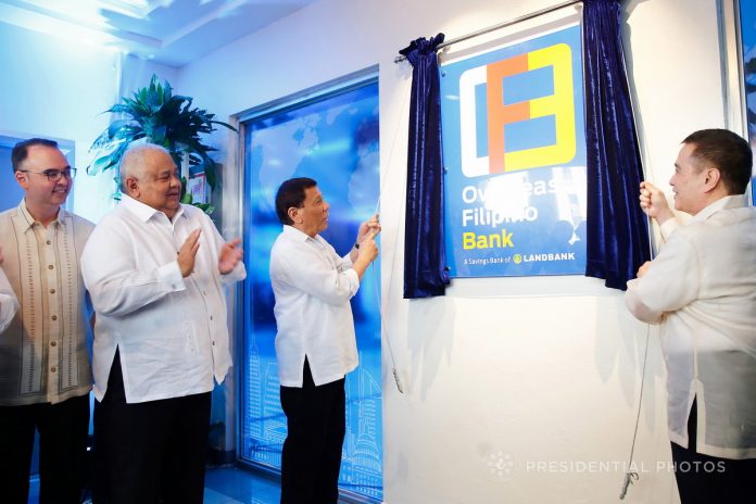 IN THE SERVICE OF OFWS. President Rodrigo Duterte leads the unveiling ceremony of the marker of Overseas Filipino Bank (OFBank) during its inauguration at the Postbank Center, Liwasang Bonifacio in Manila on Thursday. Also in the photo are Foreign Affairs Secretary Alan Peter Cayetano, Executive Secretary Salvador Medialdea and OFBank Chairman Alex Buenaventura. PRESIDENTIAL PHOTO