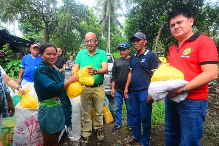 HELP FOR FLOOD VICTIMS. Distribution of relief goods and food packs to victims displaced by the December flashfloods in the hinterland areas of the Third Congressional District occupied the time and effort of Rep. Alberto T. Ungab and his allies among barangay leaders during the month of January, according to belated reports from Calinan. In this January 5, 2018 photo release, Rep. Ungab hands over a pack of food and relief items to a lady. With him are barangay captains Rogelio dela Cruz of Dalagdag, Cesario Darunday of Dacudao and Ramon Bargamento of Mintal. Photo by Clemme Kane