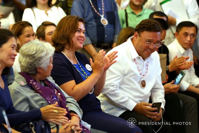 NO. 1 FAN. Davao City Mayor Sara Duterte-Carpio applauds as his father President Rodrigo Duterte delivers his speech during the launching of the Malasakit Program at the Vicente Sotto Memorial Medical Center in Cebu City on Monday. Also in the photo are Education Secretary Leonor Briones and Presidential Spokesperson Harry Roque. PRESIDENTIAL PHOTO