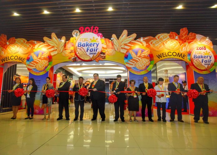 MILESTONE. Bakery Fair chair Bien Enrico Ah (center), Filipino-Chinese Bakery Association, Inc. president Peter Fung (6th from right), and Councilor Al Ryan Alejandre (5th from left) lead the cutting of ribbon to mark the opening of 2018 Bakery Fair-Davao at SMX Convention Center in Lanang on Thursday. LEAN DAVAL JR