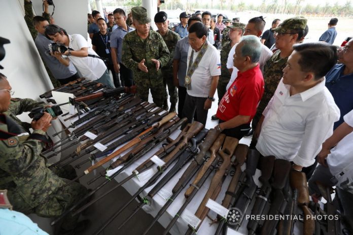 President Rodrigo Duterte leads the inspection of the firearms seized from the New People’s Army on the sidelines of his attendance to the ceremonial distribution of the Certificates of Land Ownership Award (CLOAs) to the Agrarian Reform Beneficiaries at the Sultan Kudarat Sports and Cultural Center in the Municipality of Isulan, Sultan Kudarat on Monday. Joining the President are 6th Infantry Division Commander Major General Arnel dela Vega, Sultan Kudarat First District Representative Suharto Mangudadatu and Special Assistant to the President Christopher Lawrence Go. PRESIDENTIAL PHOTO