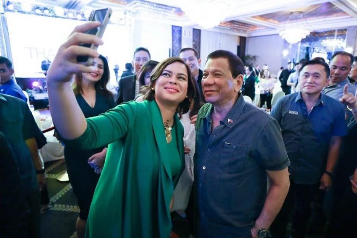 President Rodrigo Duterte poses for a group photo with his daughter, Davao City Mayor Sara Duterte-Carpio during a Hugpong ng Pagbabago (HNP) gathering. Mayor Sara and President Duterte, emerged as top picks for the 2022 presidential and vice presidential derbies, respectively, according to the private polling firm Pulse Asia. Presidential Photo