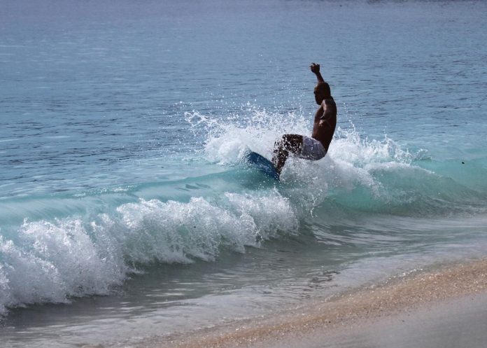 A resident of Mati City showcases his skimboarding skills at a beachfront in Dahican. The Department of Tourism 11 (DOT 11) said as the tourism sector is on the verge of recovery, the agency is seeing the the surge of tourists coming to Davao Oriental. Edge Davao
