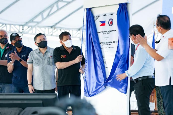 President Rodrigo Duterte leads the unveiling of the marker of the Tacloban City Bypass Road during the inauguration ceremony in Barangay Caibaan, Tacloban City on March 17, 2022. With the President are Presidential Assistant for the Visayas Secretary Michael Lloyd Dino, Senator Christopher Lawrence Go, Public Works and Highways Acting Secretary Roger Mercado, Leyte District 1 Representative Martin Romualdez, and Tacloban City Mayor Alfred Romualdez. PRESIDENTIAL PHOTO