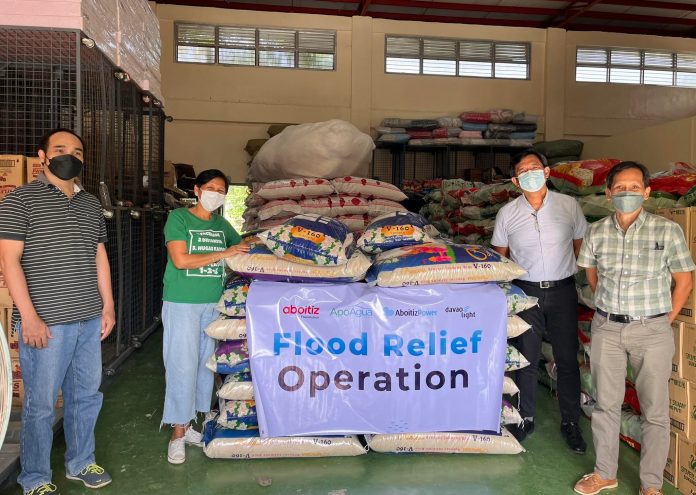 avao City. Davao Light officers led by President and COO Rodger Velasco turn over 72 sacks of rice to the flood victims in Davao City through CSWDO Department Head II, Atty. Marlisa Gallo.