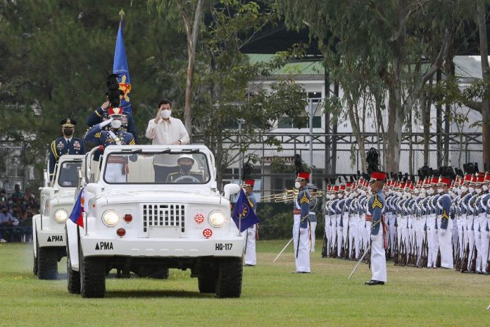 President Rodrigo Duterte salutes past the color guard while onboard the command car in the trooping-the-line ceremony during the Philippine Military Academy commencement exercises at the Fajardo Grandstand, Borromeo Field in Fort Gen. Gregorio H. del Pilar, Baguio City on May 15, 2022. PRESIDENTIAL PHOTO