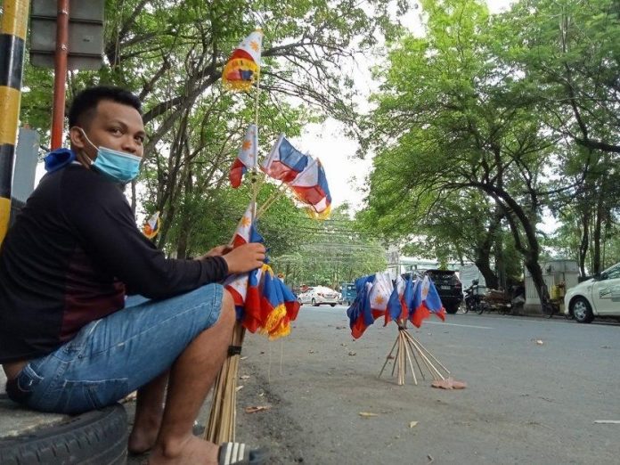 A vendor selling miniature Philippine flags waits for buyers along Tionko Avenue in Davao City on Wednesday (June 8, 2022). The country celebrates its 124th Independence Day on Sunday (June 12, 2022). MindaNews photo by GREGORIO BUENO