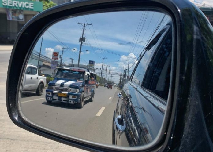 A public utility jeepney (PUJ) is pictured from a side mirror of a vehicle along Lanang, Davao City on Thursday. Minimum fare of PUJs in Davao City increases from P10 to P11 starting today, July 1, after the LTFRB approved the nationwide provisional jeepney fare hike. Edge Davao