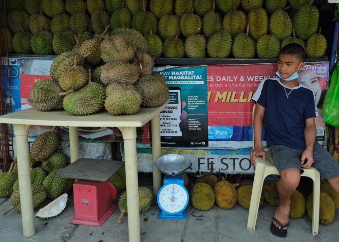 A durian vendor waits for customers at Magsaysay Fruit Stalls in Davao City on Monday. The Department of Agriculture in Davao Region (DA-11) has urged durian growers to expand or plant more trees with focus on improved varieties as the market demand has skyrocketed. Edge Davao