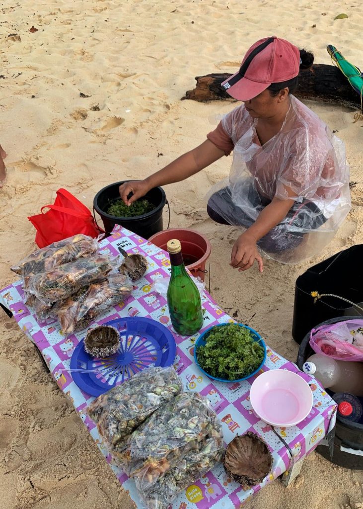 A vendor prepares fresh sea produce in anticipation of the influx of tourists at one of the islands of Britania Islands in San Agustin, Surigao del Sur over the weekend. LEAN DAVAL JR.