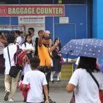 A personnel of the City Transport and Traffic Management Office (CTTMO) mans the traffic to let the pedestrian, which are mostly elementary students, safely cross a very busy San Pedro Street in Davao City on Friday. LEAN DAVAL JR.