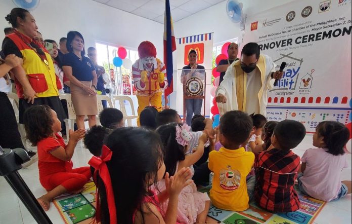 A Ronald McDonald mascot cheers up the children, who are beneficiaries of Bahay Bulilit Learning Center during the facility's turn over to Barangay Tibungco on Thursday. Bahay Bulilit Learning Center is a program of Ronald McDonald House Charities in partnership with the local government unit and the Department of Social Welfare and Development. LEAN DAVAL JR.