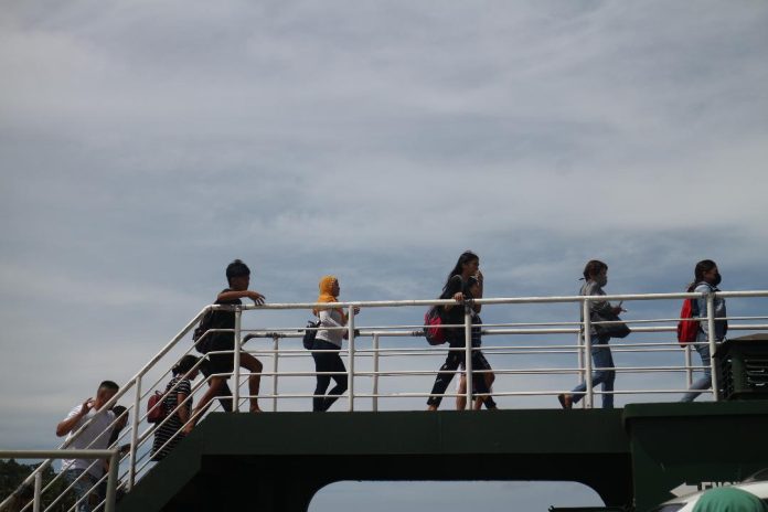 People are seen boarding a roll on/roll off (Roro) vessel plying the Sasa-Island Garden City of Samal (IGaCoS) route at Sasa Ferry Wharf in Davao City on Friday. The local government unit of IGaCoS has declared a state of calamity on Thursday due to the ongoing power crisis in the city. LEAN DAVAL JR