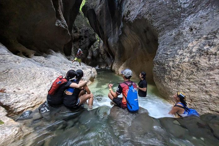 Trekkers pose for a picture in the Sikyop underground river in Barangay Rogongon, Iligan City Tuesday morning (11 July 2023). The site, operated by the Sikyop Agricultural Cooperative, is the must-see destination in Iligan for people who love the outdoors. “Sikyop” is Higanonon term for “hidden paradise.” MindaNews photo by BOBBY TIMONERA