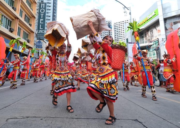 A contigent for the 2023 Kadayawan sa Davao Festival's Indak Indak sa Kadayawan Davao City school based category perform along C.M. Recto Avenue in Davao City on Saturday.LEAN DAVAL JR.