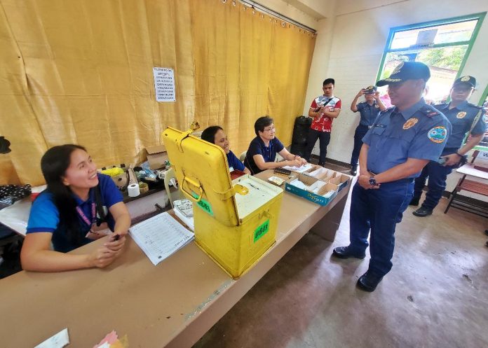 Police Regional Office 11 (PRO 11) director BGen. Alden Delvo talks to electoral board members at cluster precinct No. 841 inside Daniel R. Aguinaldo National High School (DRANHS) in Matina Crossing, Davao City where Vice President and Education Secretary Sara Duterte casted her vote on Monday morning. Delvo made rounds in Davao del Sur towns that are under the election areas of concern and in some schools in Davao City. LEAN DAVAL JR