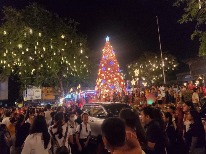 Dabawenyos gather at Quezon Park as the giant Christmas tree and the Christmas installations illuminate the City Hall area after Mayor Sebastian 