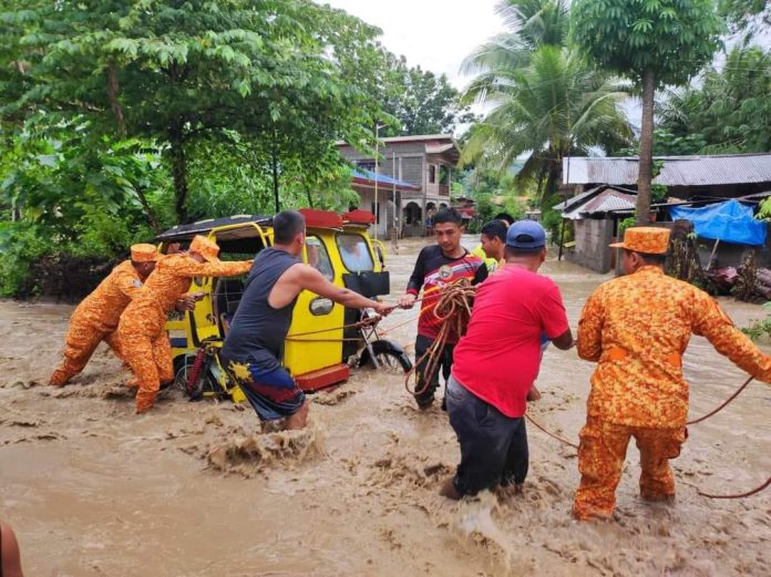 Personnel from the Bureau of Fire Protection assist in the rescue and evacuation of residents of Sitio Libtong, Barangay Central in Manay, one of the areas in the province heavily affected by the flooding brought by Tropical Cyclone Kabayan on Monday, December 18, 2023. (Photo Provincial Government of Davao Oriental)