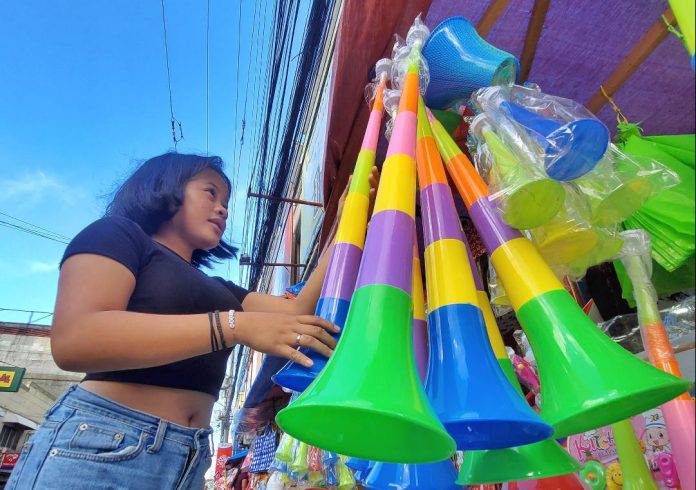 A vendor displays plastic horns at a makeshift stall along Ilustre Street in Davao City on Friday in anticipation of the influx of people who will buy noisemaker items for the upcoming New Year's eve celebration. The Davao City Police Office (DCPO) has reminded Dabawenyos to observe the implementation of the firecracker ban to keep the New Year’s celebration safe and peaceful. LEAN DAVAL JR