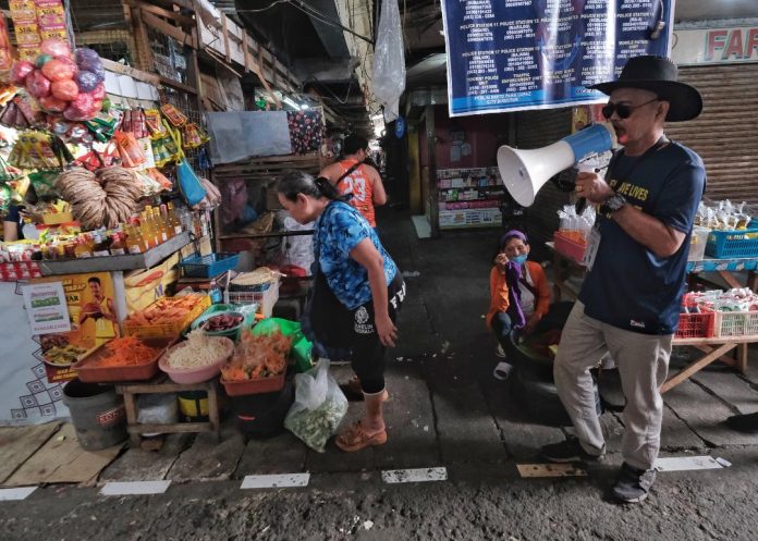 To maintain an orderly operation at Bankerohan Public Market in Davao City, a personnel of the City Economic Enterprise Office roams around the market and remind the vendors using a megaphone on Thursday to always follow the policies and stay at their designated areas. LEAN DAVAL JR