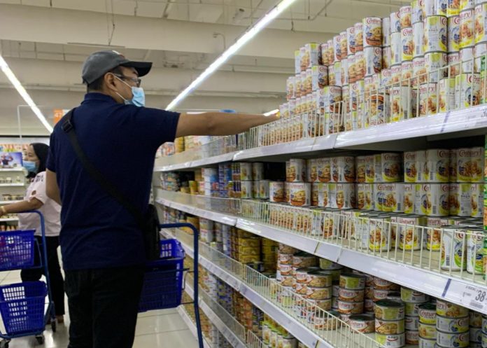 A man shops for canned goods at a supermarket in Ecoland, Davao City. The Department of Trade and Industry (DTI) has agreed with the request of some manufacturers to increase suggested retail prices (SRPs) of products under basic necessities and prime commodities (BNPC). LEAN DAVAL JR