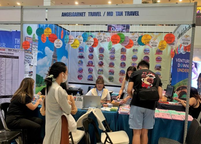 Clients gather at the booth of Angelgarnet Travel and MD Tan Travel to check on the airfare discounts and other offerings during the second day of the Davao Travel Agencies Association's (DTAA's) 14th Davao Mega Travel Sale at the activity center of Ayala Malls Abreeza on Saturday. LEAN DAVAL JR