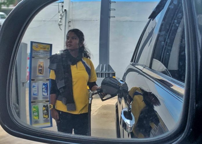 A pump attendant fills a vehicle with fuel at a gasoline station in Bo. Pampanga, Davao City. Oil companies will reduce the prices of fuel products Tuesday. LEAN DAVAL JR
