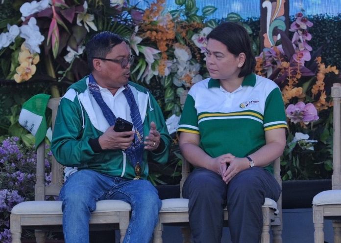 Vice President and Education Secretary Sara Duterte listens as Davao del Norte Governor Edwin Jubahib discusses matters with her during the opening of Davao Regional Athletics Association (DAVRAA) Meet held at Davao City-UP Sports Complex in Mintal, Davao City on Monday. LEAN DAVAL JR