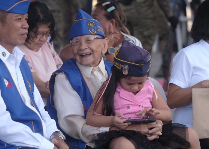 World War II veteran Teofilo Gamutan, together with his great grandchild, attends the commemoration of the 82nd Araw ng Kagitingan (Day of Valor) at the Veterans Memorial Monument in Davao City on Tuesday. Gamutan will turn 101 on July 10. LEAN DAVAL JR