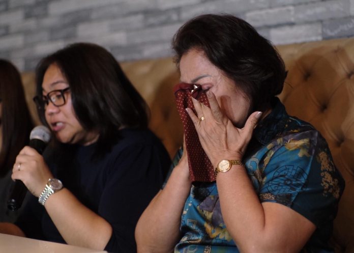 Evelyn Afdal, widow of slain retired Army Colonel Samuel Afdal, can't contain her emotion as her daughter, Christine, reads the family's statement during a presser to announce the development of the Afdal murder case held at The Royal Mandaya Hotel in Davao City on Friday. LEAN DAVAL JR
