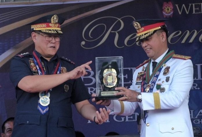 Police Regional Office 11 (PRO 11) outgoing director Brig. Gen. Alden Delvo receives a replica of his badge from Philippine National Police (PNP) deputy chief for operations Lt. Gen. Michael John Dubria during a retirement honors for him held at Camp Sgt. Quintin Merecido in Buhangin, Davao City on Thursday.LEAN DAVAL JR