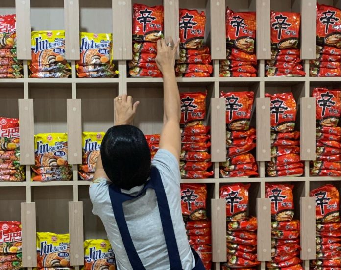 A store attendant arranges imported noodles at a snack joint offering South Korean food inside a mall along J.P. Laurel Avenue in Davao City on Wednesday. South Korean food such as spicy noodles and fried chicken are popular among Dabawenyos, specially high school and college students. LEAN DAVAL JR