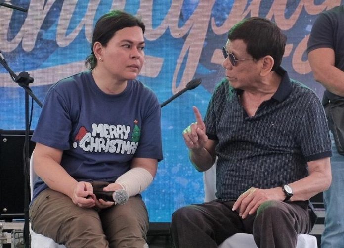 Former President Rodrigo Duterte confers with his daughter, Vice President Sara Duterte, during the annual 