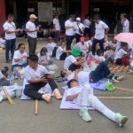 Some members of Iglesia ni Cristo (INC) take a rest on the pavement while waiting for the main program of the National Rally for Peace to start in Davao City on Monday. LEAN DAVAL JR