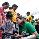 Vice President Sara Duterte chats with a young resident during the annual Christmas Day Pahalipay sa Taal in Davao City. The vice president has been impeached by the House of Representatives after obtaining 215 of its members' signature on Wednesday. The impeachment process now moves to the Senate for trial. LEAN DAVAL JR